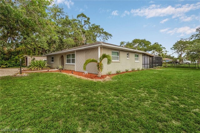 view of side of property featuring a lawn