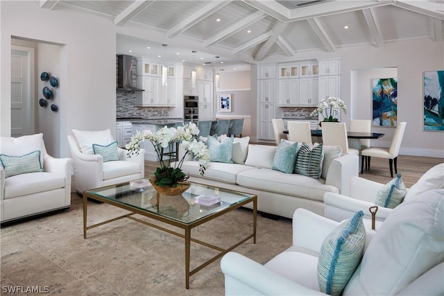 living room with vaulted ceiling with beams