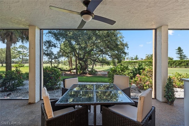 sunroom featuring ceiling fan