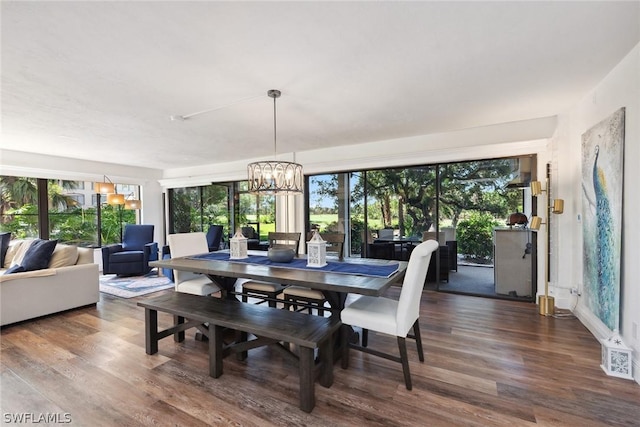 dining room with hardwood / wood-style floors and a notable chandelier