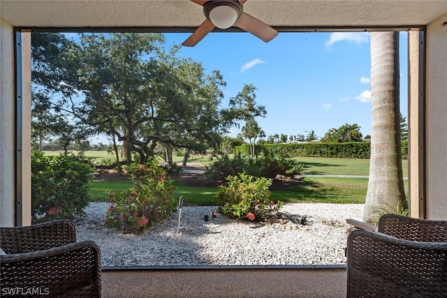 exterior space with ceiling fan