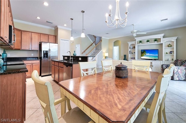 tiled dining area with ceiling fan with notable chandelier, ornamental molding, and sink