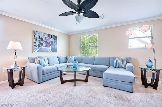 carpeted living room with ceiling fan and ornamental molding