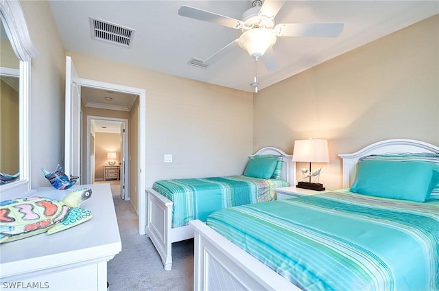 carpeted bedroom with ceiling fan and crown molding