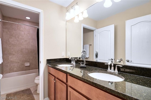 full bathroom featuring vanity, tile patterned flooring, tiled shower / bath, and toilet