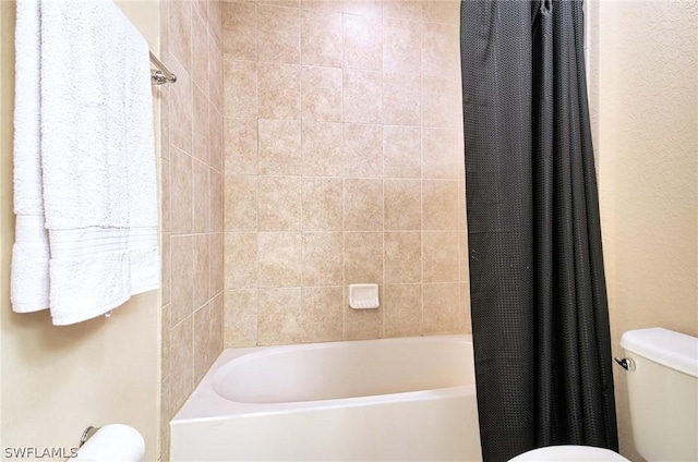 bathroom with shower / tub combo with curtain and toilet