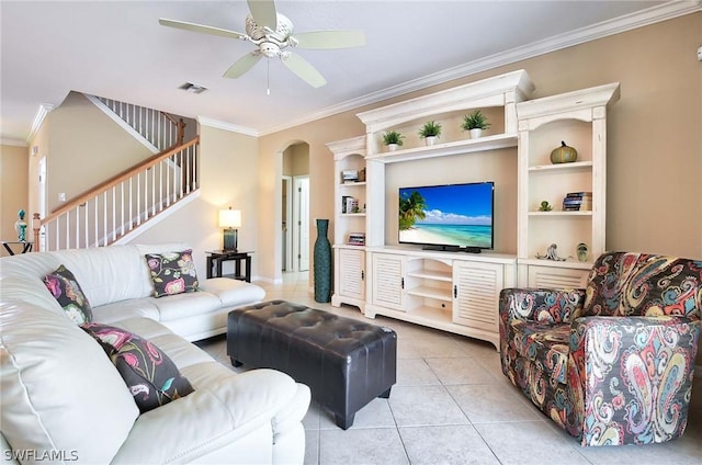 living room featuring ceiling fan, light tile patterned floors, and ornamental molding