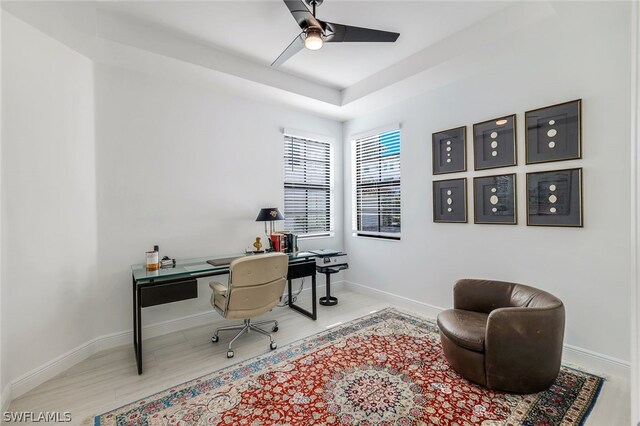 home office with ceiling fan and light hardwood / wood-style floors