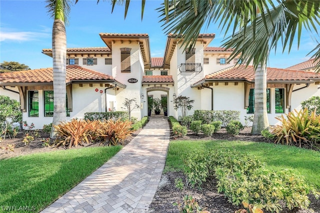 mediterranean / spanish-style house featuring a front yard