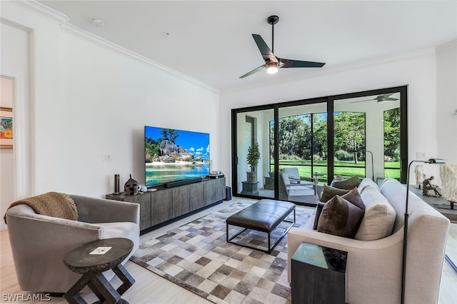 living room featuring ceiling fan, crown molding, and light hardwood / wood-style flooring