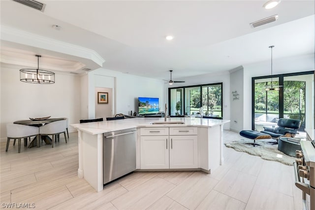 kitchen featuring pendant lighting, white cabinets, sink, stainless steel dishwasher, and an island with sink