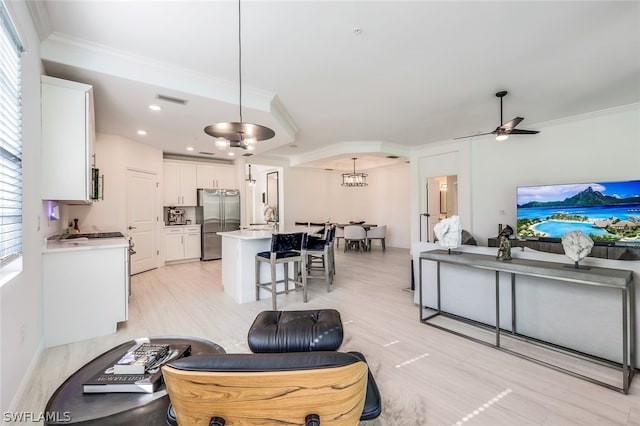 living room featuring ceiling fan, sink, crown molding, and light hardwood / wood-style flooring