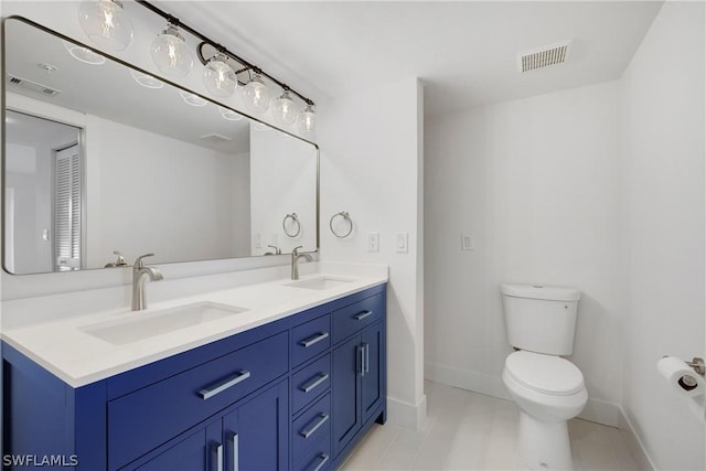 bathroom with tile patterned floors, toilet, and vanity