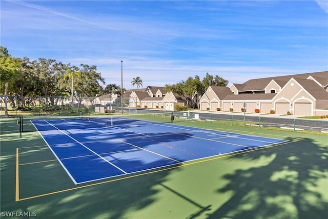 view of tennis court featuring basketball hoop