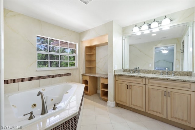 bathroom featuring tile patterned floors, vanity, and a relaxing tiled tub