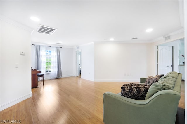 living room featuring light wood-type flooring and ornamental molding