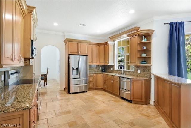 kitchen with light stone countertops, stainless steel appliances, and sink