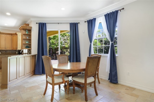 dining room with ornamental molding and sink