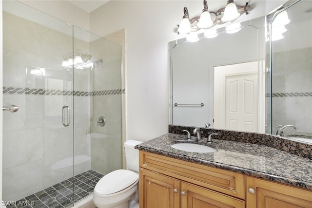 bathroom featuring toilet, vanity, and walk in shower