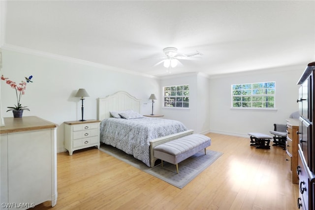 bedroom with wood-type flooring, ceiling fan, and crown molding