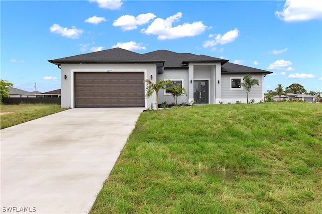 view of front facade with a garage and a front yard