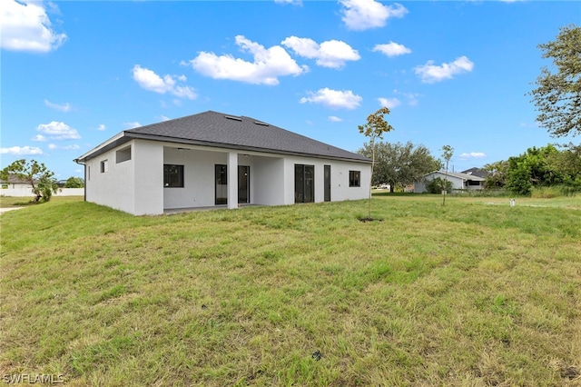 back of property featuring a yard