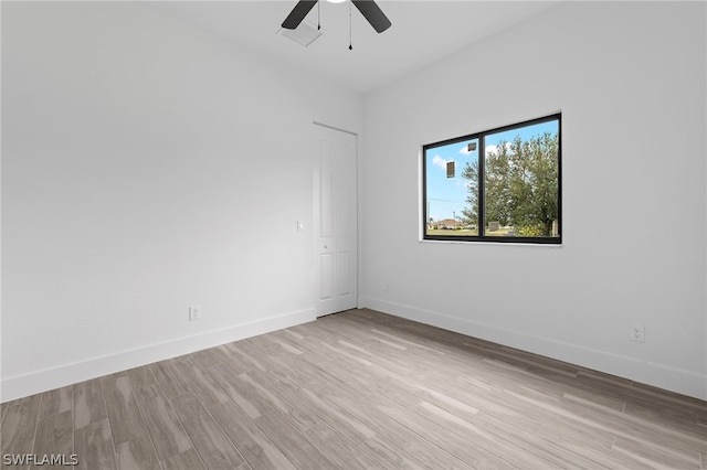 spare room featuring light wood-type flooring and ceiling fan