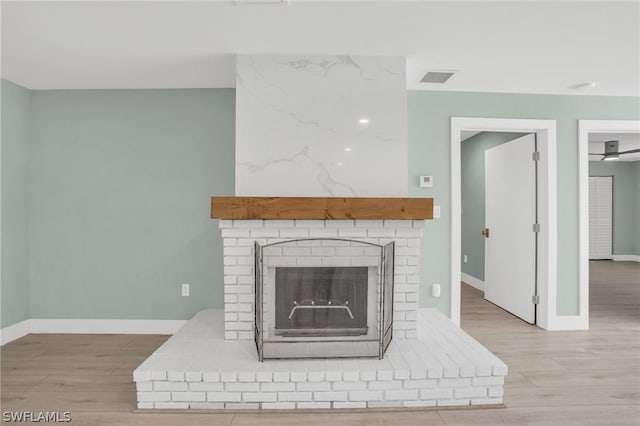 details featuring wood-type flooring and a brick fireplace