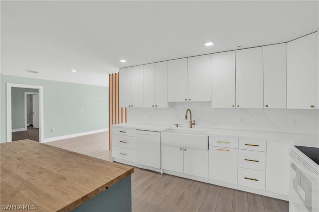 kitchen featuring sink, white appliances, white cabinets, and light hardwood / wood-style floors