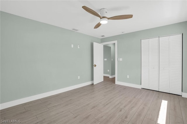 unfurnished bedroom featuring a closet, ceiling fan, and light hardwood / wood-style flooring