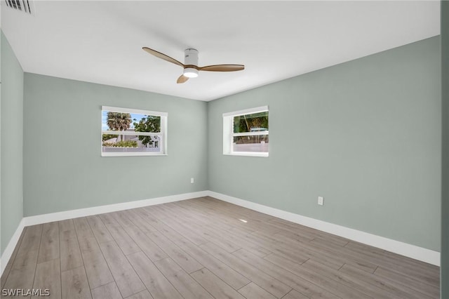 unfurnished room featuring light wood-type flooring and ceiling fan