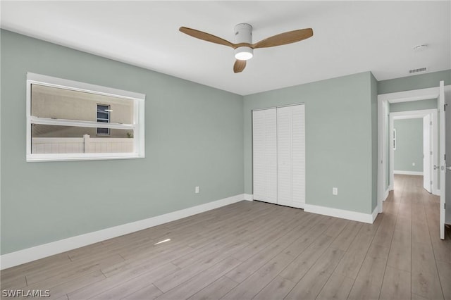 unfurnished bedroom with a closet, ceiling fan, and light hardwood / wood-style flooring