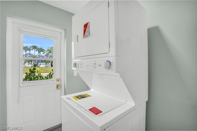 laundry area featuring stacked washer / drying machine