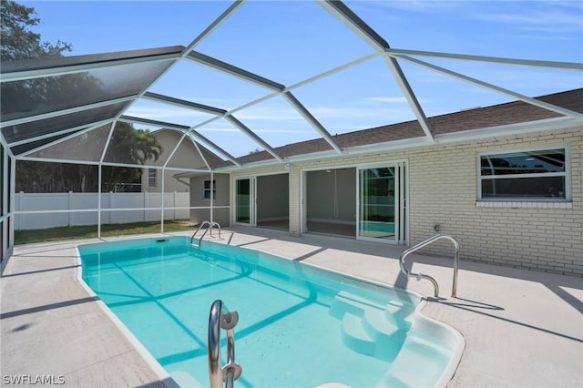 view of swimming pool featuring a lanai, a patio area, fence, and a fenced in pool