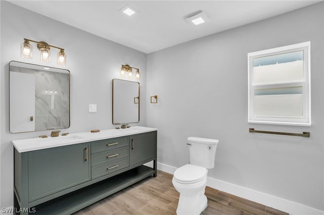 bathroom featuring toilet and vanity