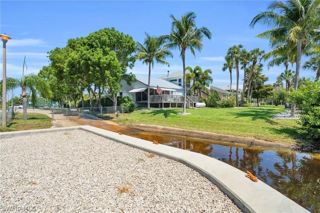 view of home's community featuring a water view and a yard