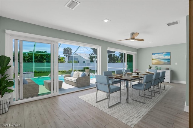 sunroom / solarium featuring visible vents and a ceiling fan