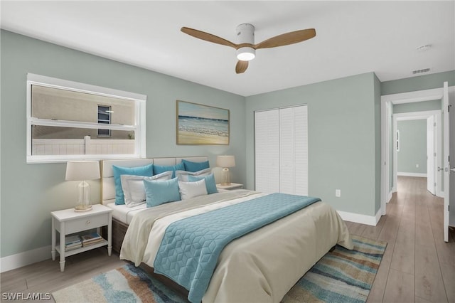 bedroom with light wood-type flooring, baseboards, and visible vents