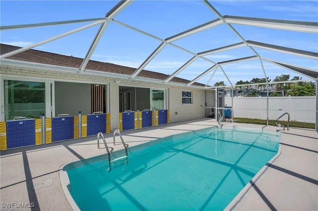 view of pool with glass enclosure, a patio area, fence, and a fenced in pool