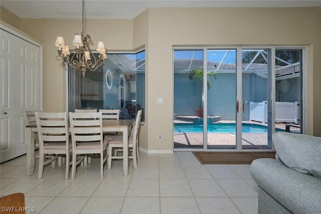 dining area featuring tile patterned flooring and an inviting chandelier