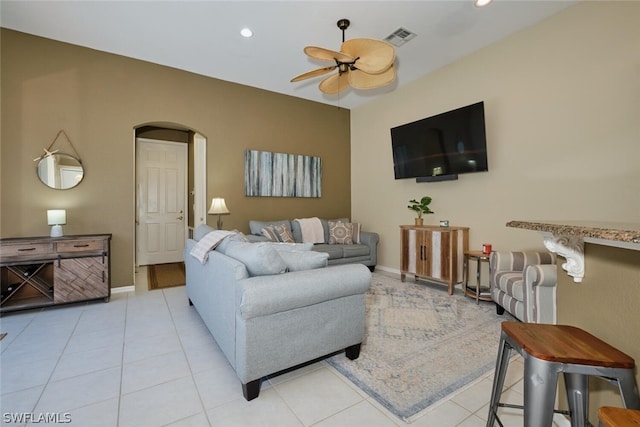 tiled living room with ceiling fan