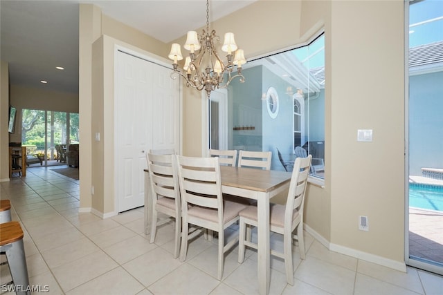 dining room with light tile patterned floors and a notable chandelier