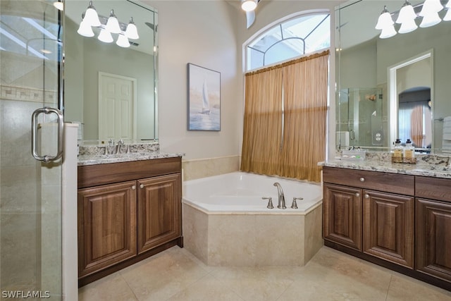 bathroom with tile patterned flooring, vanity, and shower with separate bathtub