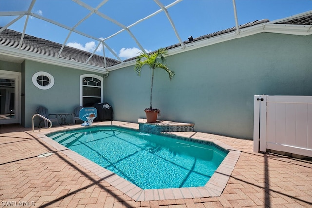 view of pool with a lanai and a patio