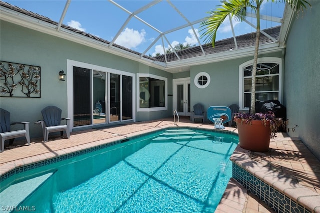 view of swimming pool with a lanai, a patio, french doors, and pool water feature