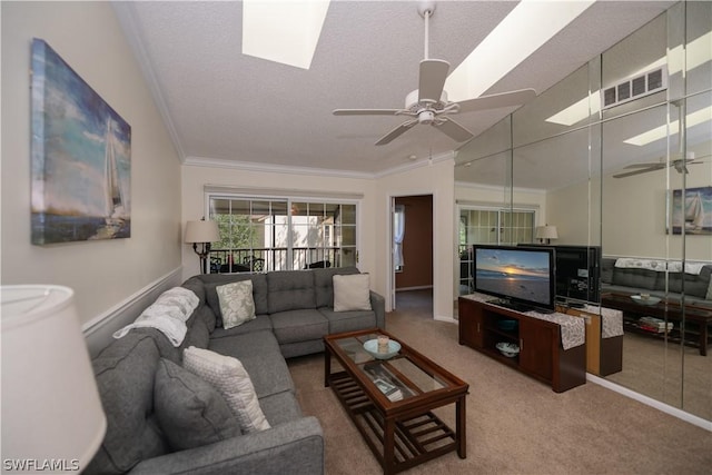 living room featuring crown molding, vaulted ceiling, carpet flooring, ceiling fan, and a textured ceiling