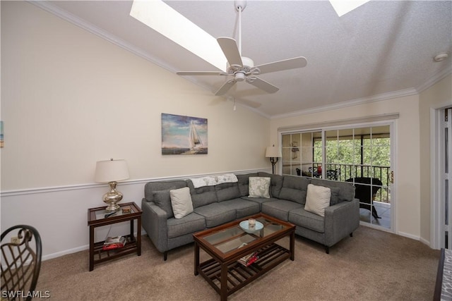 carpeted living room featuring ceiling fan, vaulted ceiling, and ornamental molding