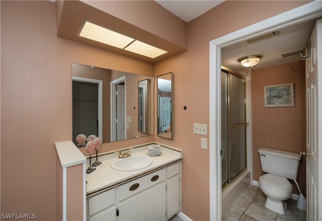 bathroom with tile patterned flooring, vanity, and toilet