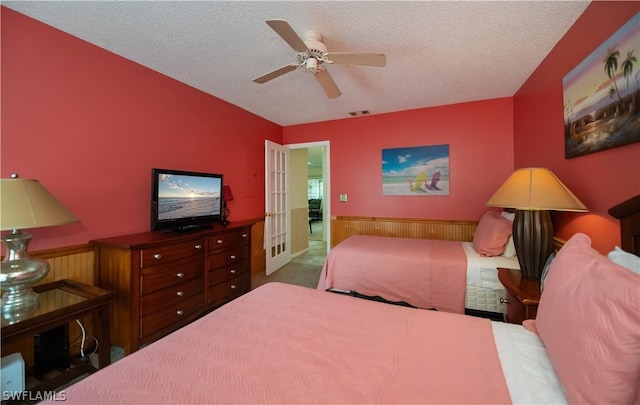 bedroom with french doors, a textured ceiling, and ceiling fan