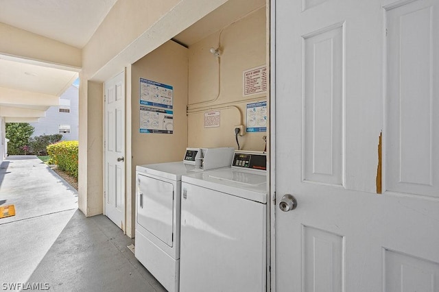 clothes washing area featuring washer and dryer